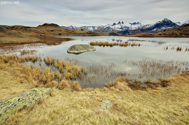 Photograph of lake Guichard and Aiguilles d'Arves mountains in autumn