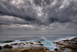 Photo of the mediterranean coast under an impressive cloudy sky