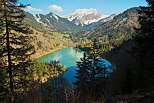 Image of a springtime landscape around lake Vallon and Roc d'Enfer mountain in Bellevaux